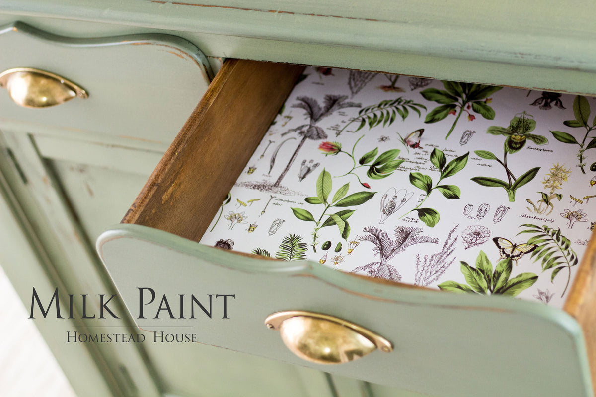 Green drawer with brass handle, floral liner; labeled Acadia Pear Milk Paint by Homestead House.