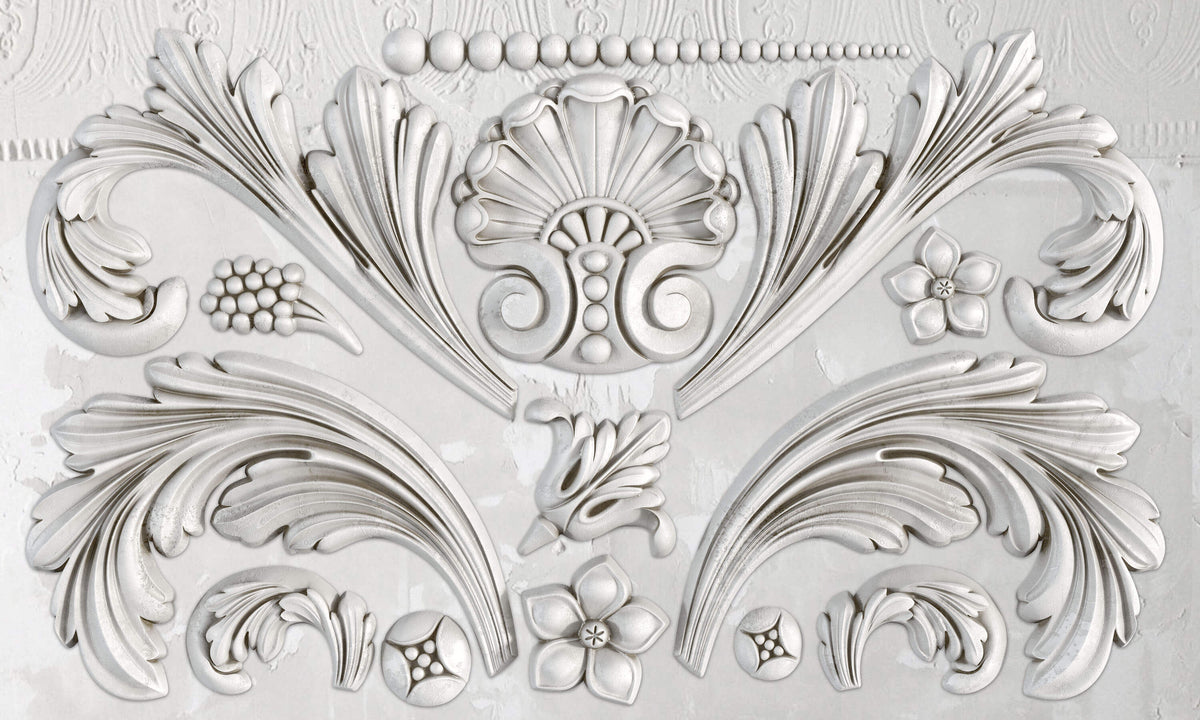 White relief made with I.O.D. Acanthus Scroll Mould, displaying acanthus leaves, flowers, and geometric accents.