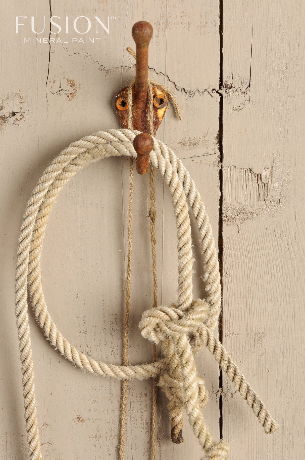 Rusted hook with coiled rope on a weathered Algonquin by Fusion Mineral Paint wall; logo in corner.