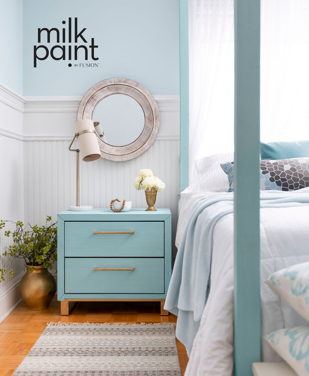 Blue nightstand with two drawers, painted in Fusion Mineral Paint Amalfi Coast. Lamp, flowers, and mirror included.