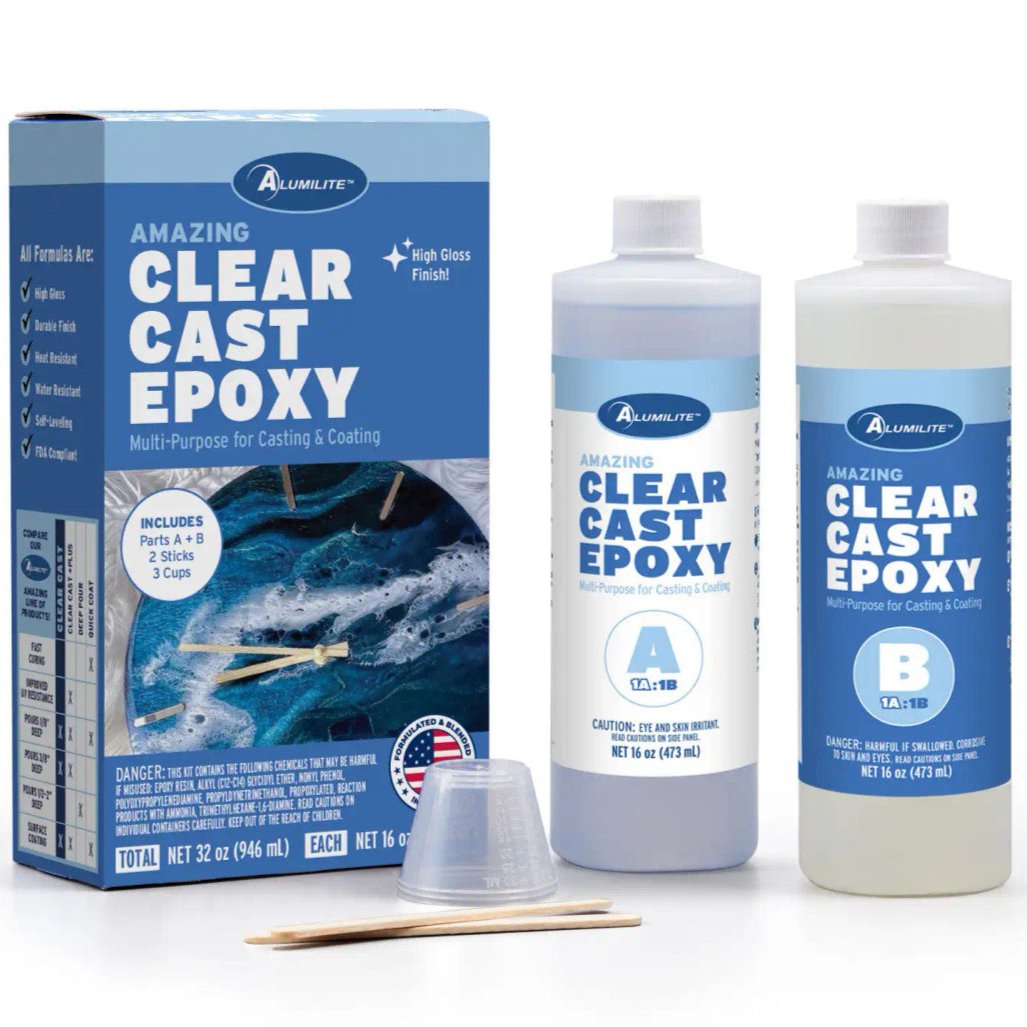Box with two bottles of Notions Amazing Clear Cast Epoxy by Alumilite, plus stir sticks and measuring cups.