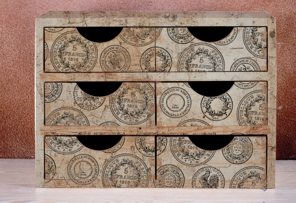 Small wooden cabinet with six drawers, decorated with IOD Antiquities Stamp by Iron Orchid Designs.