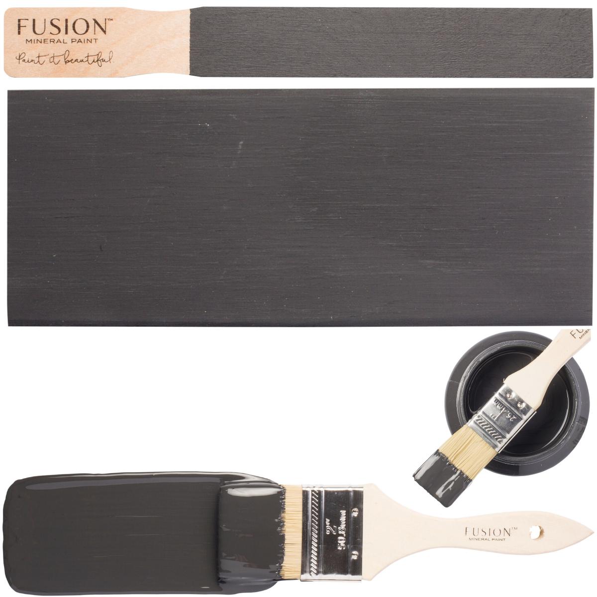 Ash by Fusion Mineral Paint in dark charcoal grey shown on stirrer, surface, brush, and can.