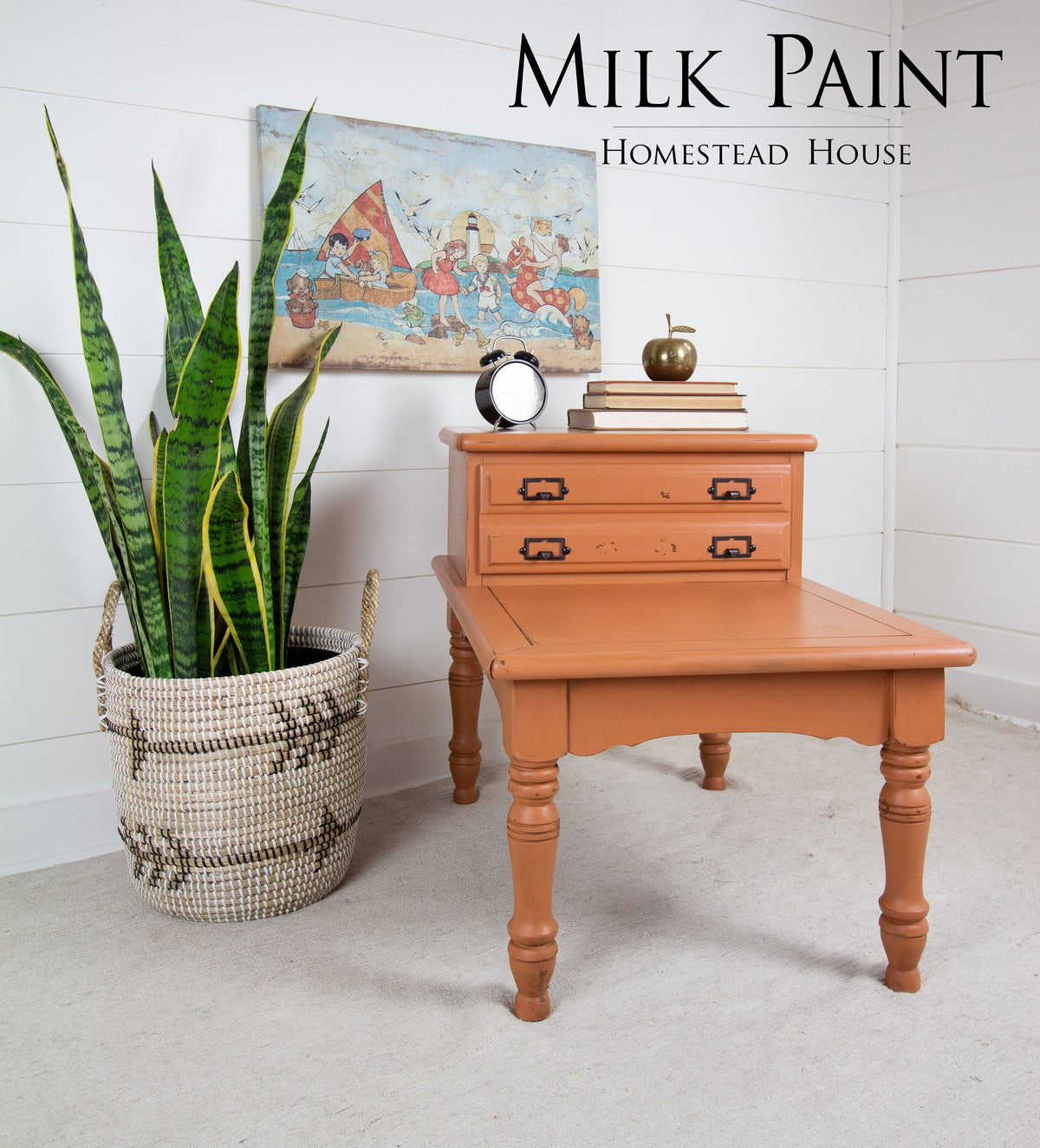 Orange side table painted in Homestead House Autumn Leaves Milk Paint; “Milk Paint” text and art visible on wall.