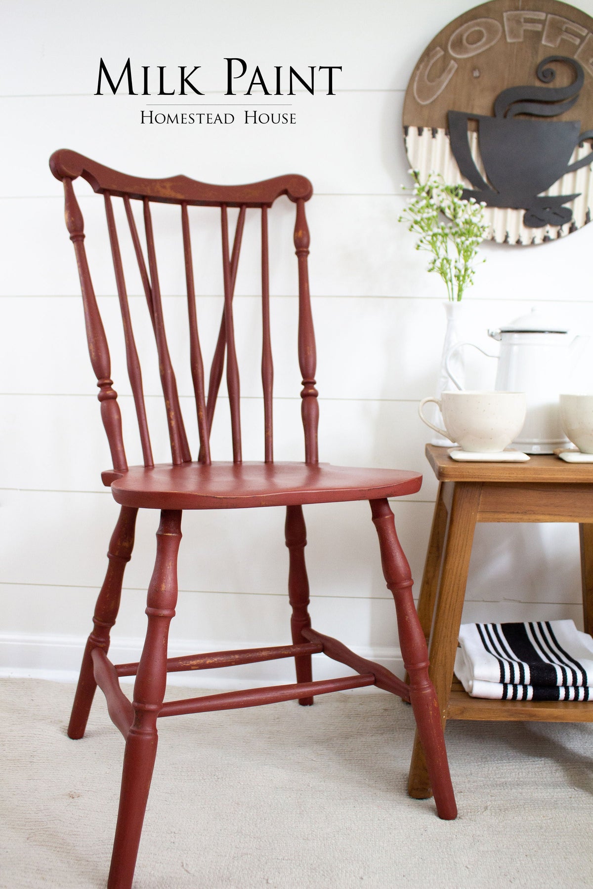 Red chair painted with Homestead House Barn Red Milk Paint positioned beside a table.