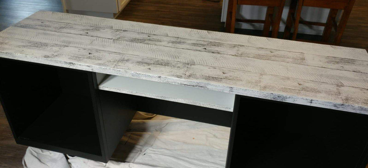 Wooden table with distressed white top, two open shelves, and I.O.D. Barnwood Planks Stamp detailing.