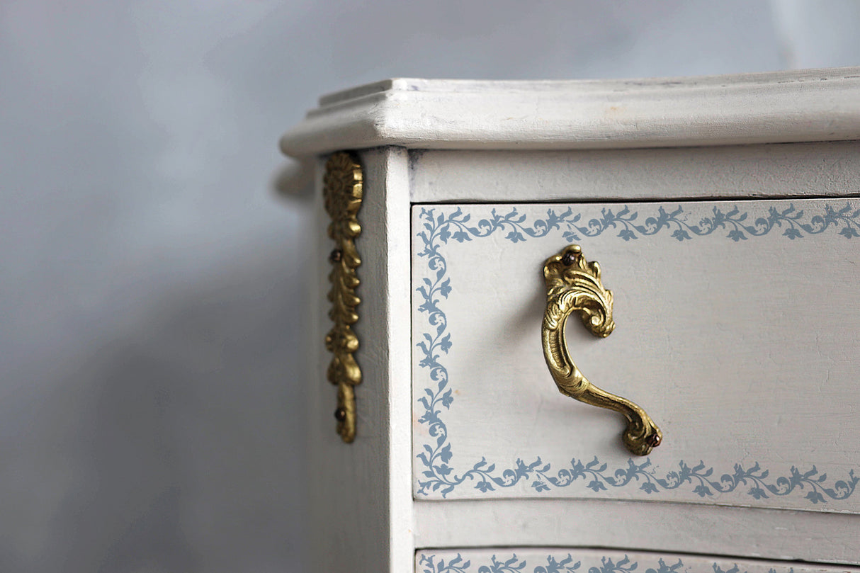White drawer with gold accents, blue floral design, and I.O.D. Bella Stamp (Retired) by Iron Orchid Designs.