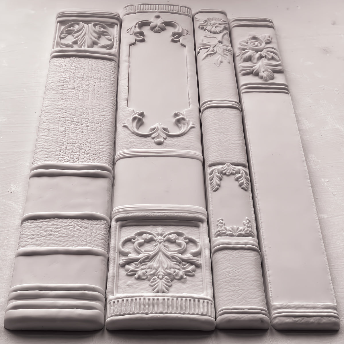 Bookish Mould by I.O.D. featuring vintage-style book spine tiles arranged side by side for faux library decor.