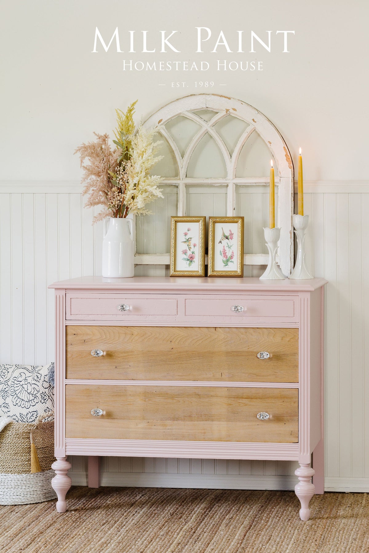 Pink and wood dresser painted with Homestead House Bouquet Milk Paint, decorated with candles and a white arched mirror.