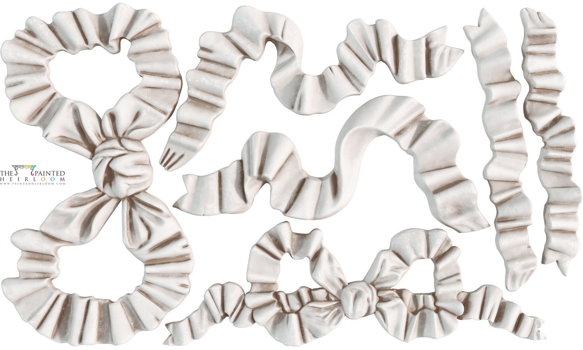 White satin bows and ribbons made with I.O.D. Bows Mould by Iron Orchid Designs on a white background.