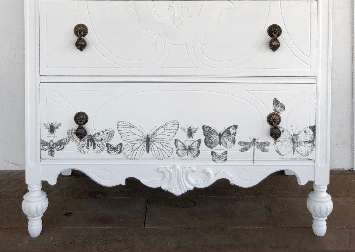White dresser with ornate legs, decorated using reusable masks and I.O.D. Butterflies Stamp by Iron Orchid Designs.