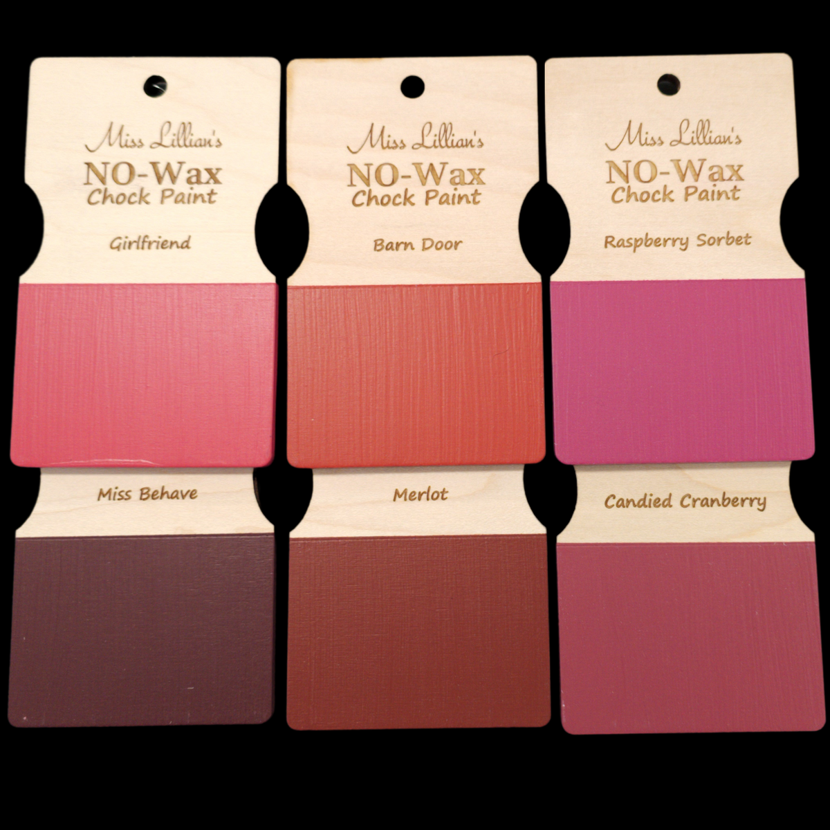 Six Girlfriend No-Wax Chock Paint samples by Miss Lillian’s in pink and red shades, labeled for furniture restoration.
