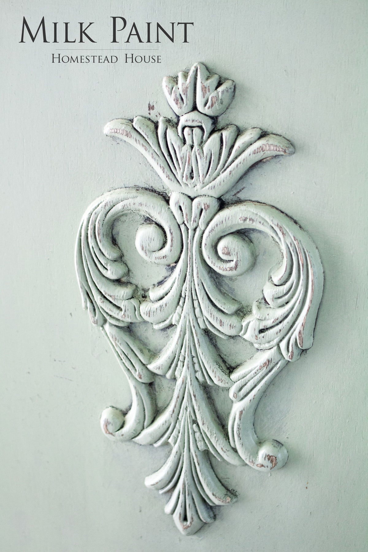 Distressed white applique on pale green, “Cartier Milk Paint by Homestead House” text above.