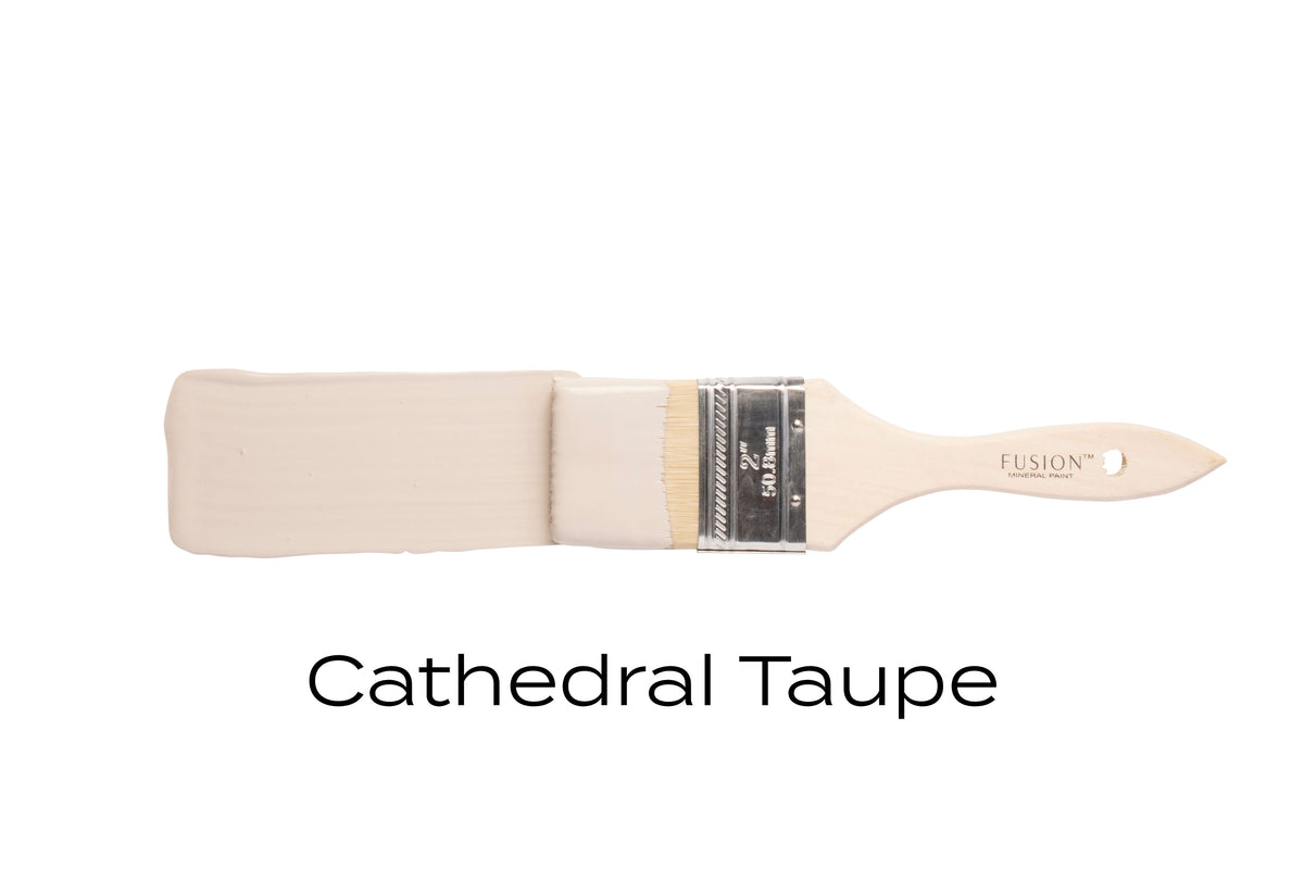 Paintbrush with light taupe Fusion Mineral Paint shown above a swatch labeled ‘Cathedral Taupe’.