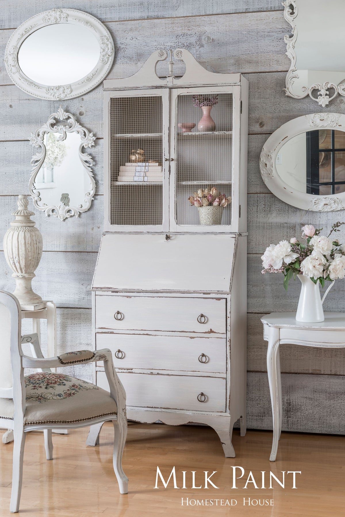 White furniture painted with Cathedral Taupe Milk Paint by Homestead House, shown against a rustic wood wall.
