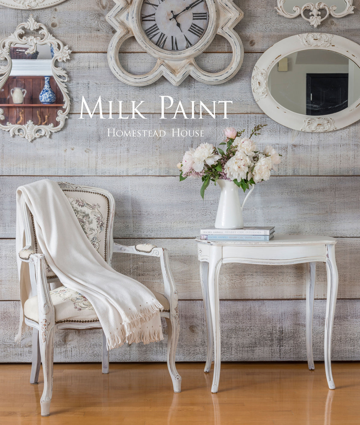 Vintage chair with throw, white table, and mirrors in front of wood wall painted Cathedral Taupe by Homestead House.