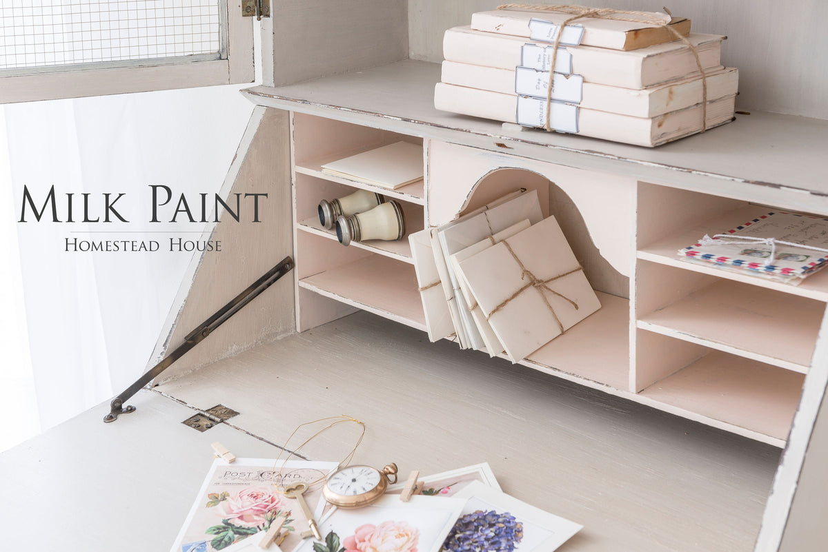 White desk with decor set against a wall painted Cathedral Taupe Milk Paint by Homestead House.