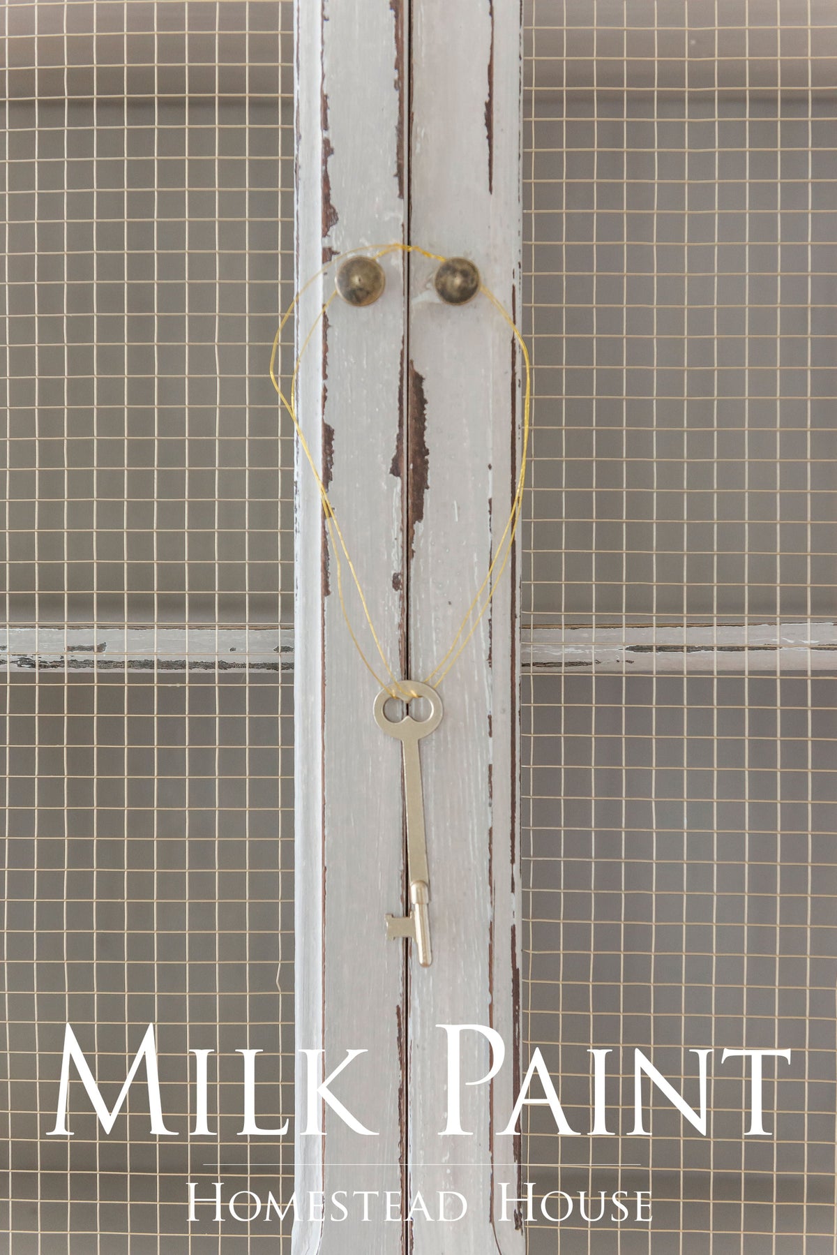 Vintage key hanging on white wire mesh cabinet finished in Cathedral Taupe Milk Paint by Homestead House.