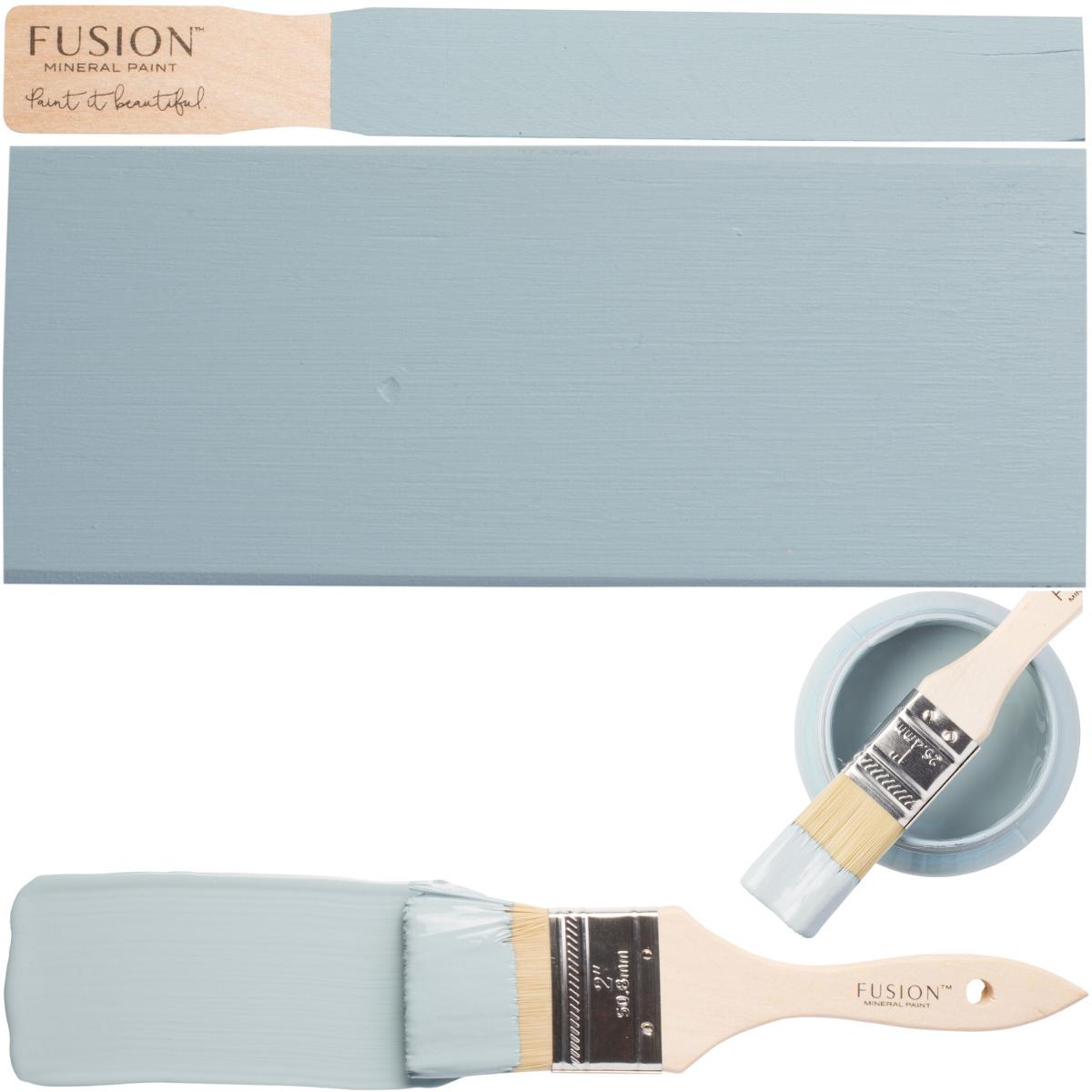 Champness Fusion Mineral Paint brush beside matte wood samples and a cup with more paint and another brush.