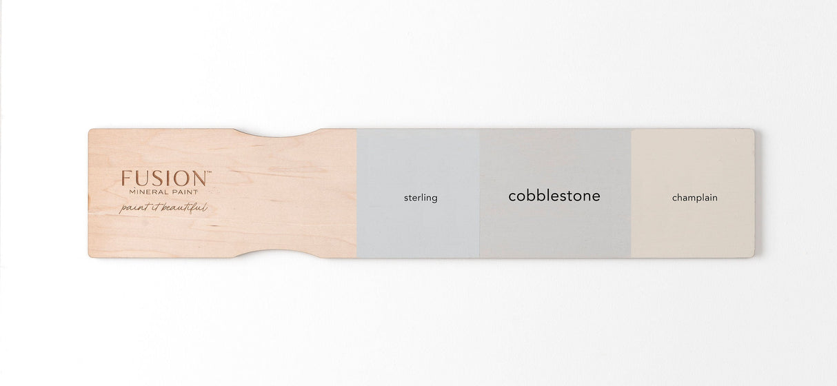Wooden swatch displaying Fusion Mineral Paint colors: Sterling, Cobblestone, and Champlain.