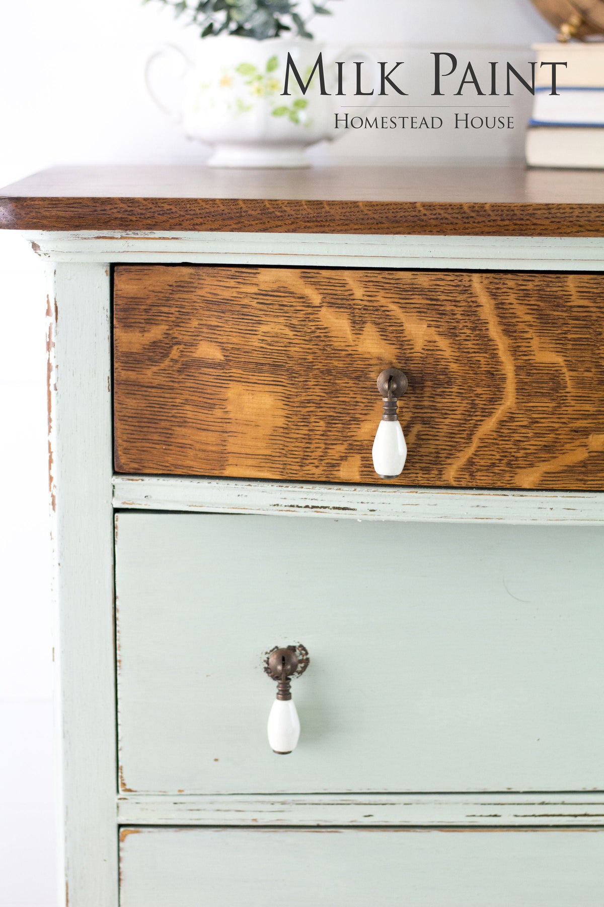 Wooden dresser with green Craftsman Milk Paint by Homestead House drawers, dark wood top, and ceramic pulls.