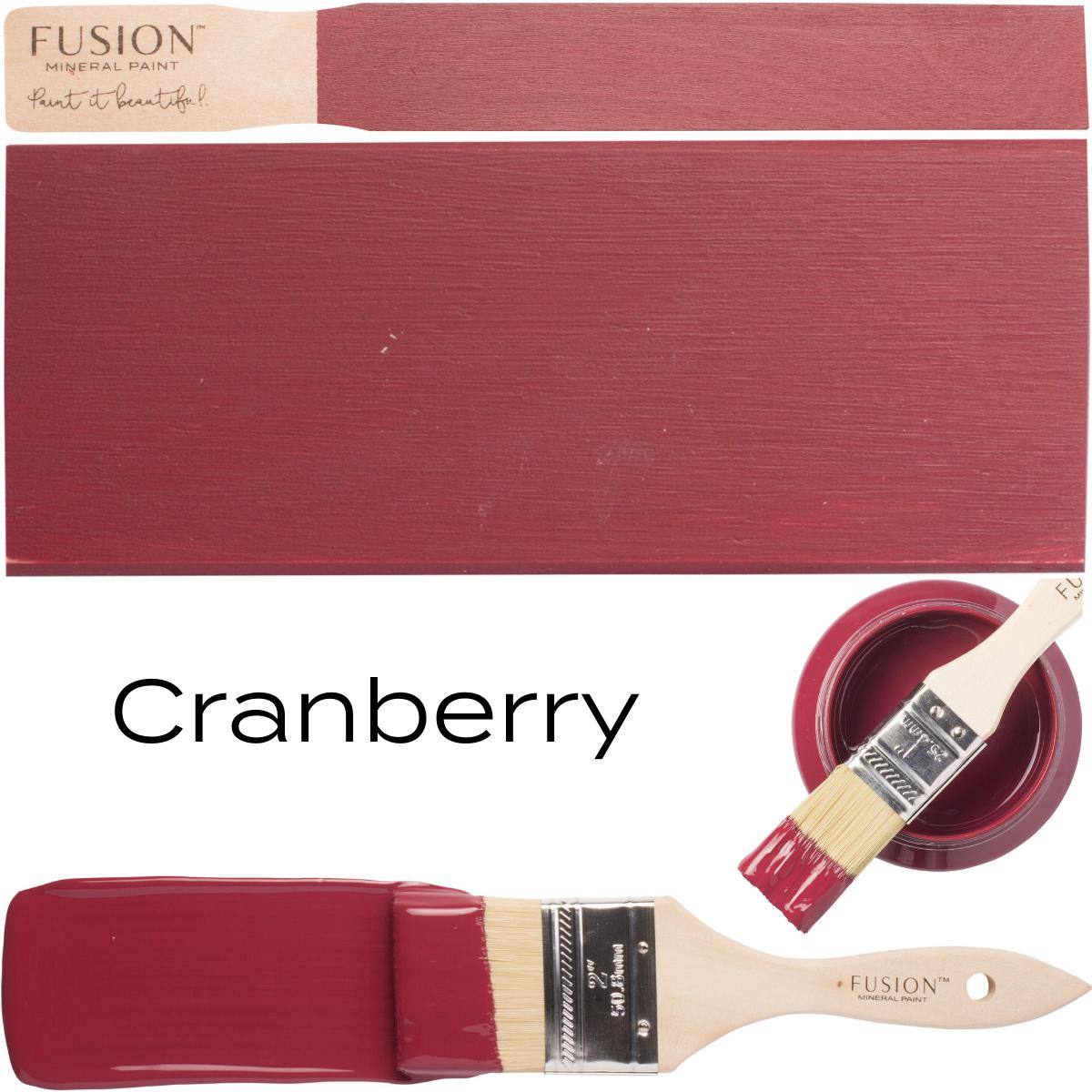 Paintbrush with Fusion Mineral Paint Cranberry, next to its color swatch and open paint can.