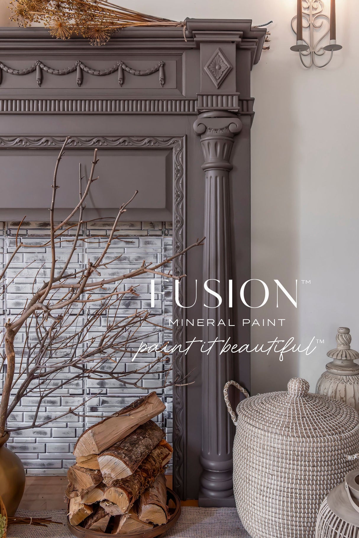 Dark gray ornate fireplace with stacked firewood, wicker basket, and Elmwood Fusion Mineral Paint finish.