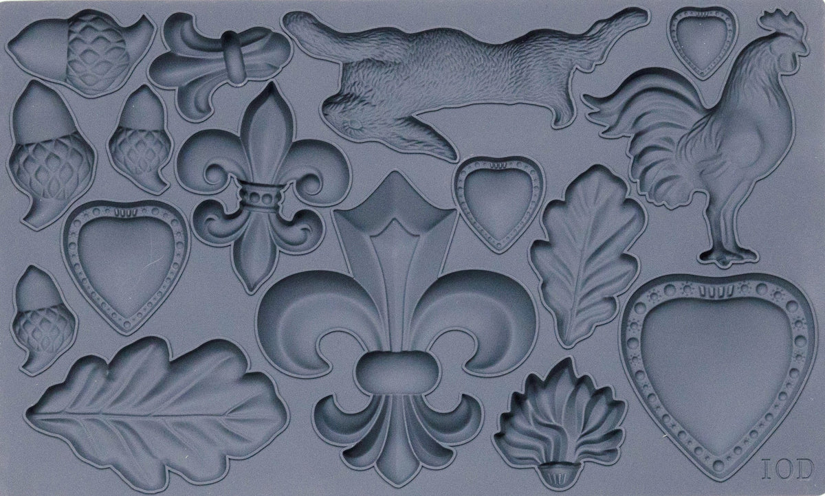 Fleur-de-lis Mould by I.O.D. in gray silicone with hearts, leaves, acorns, rabbit, rooster, and fleur-de-lis shapes.