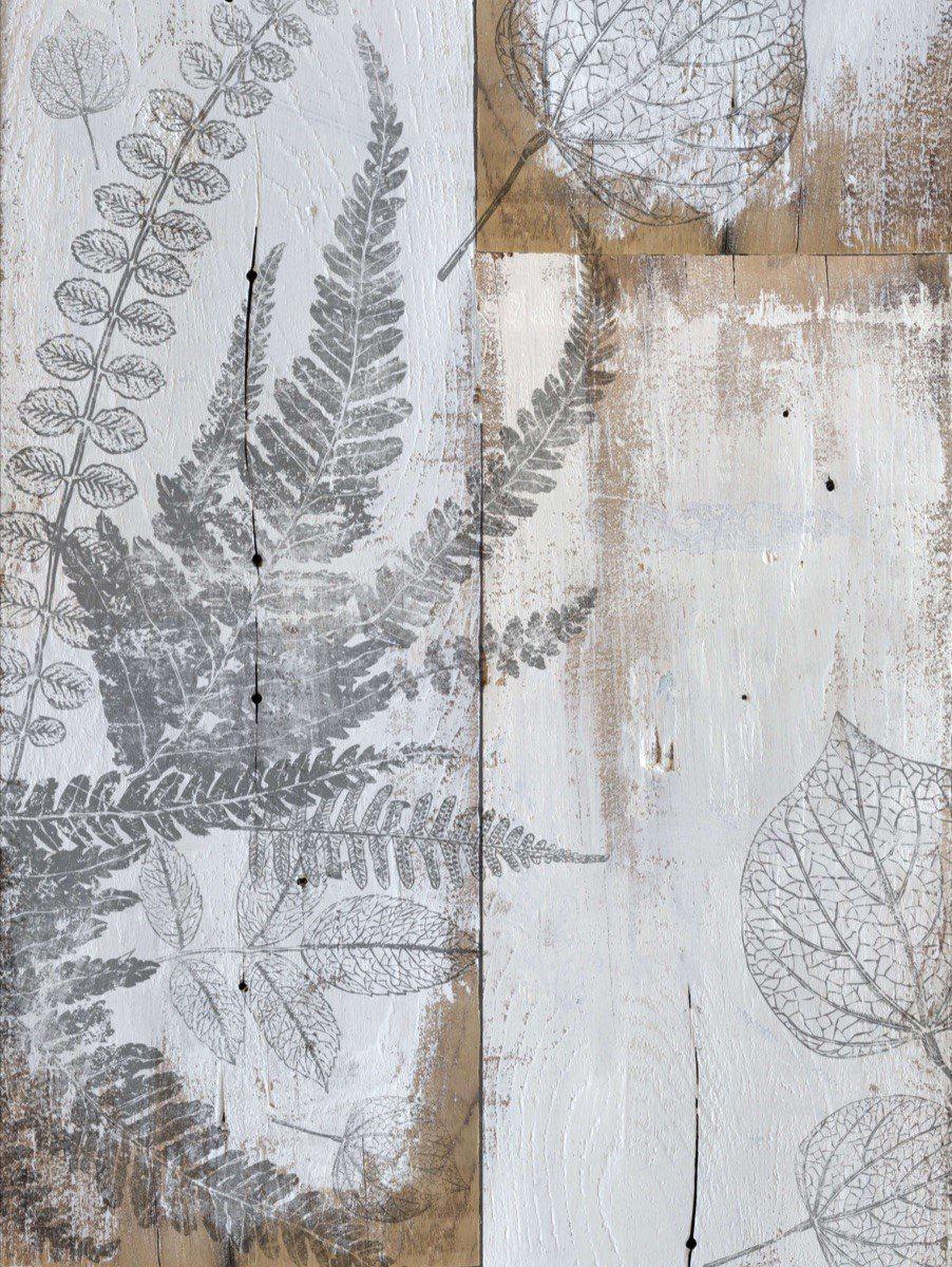 Gray and white Fronds Stamp by IOD leaf prints on rustic textured wood panels.