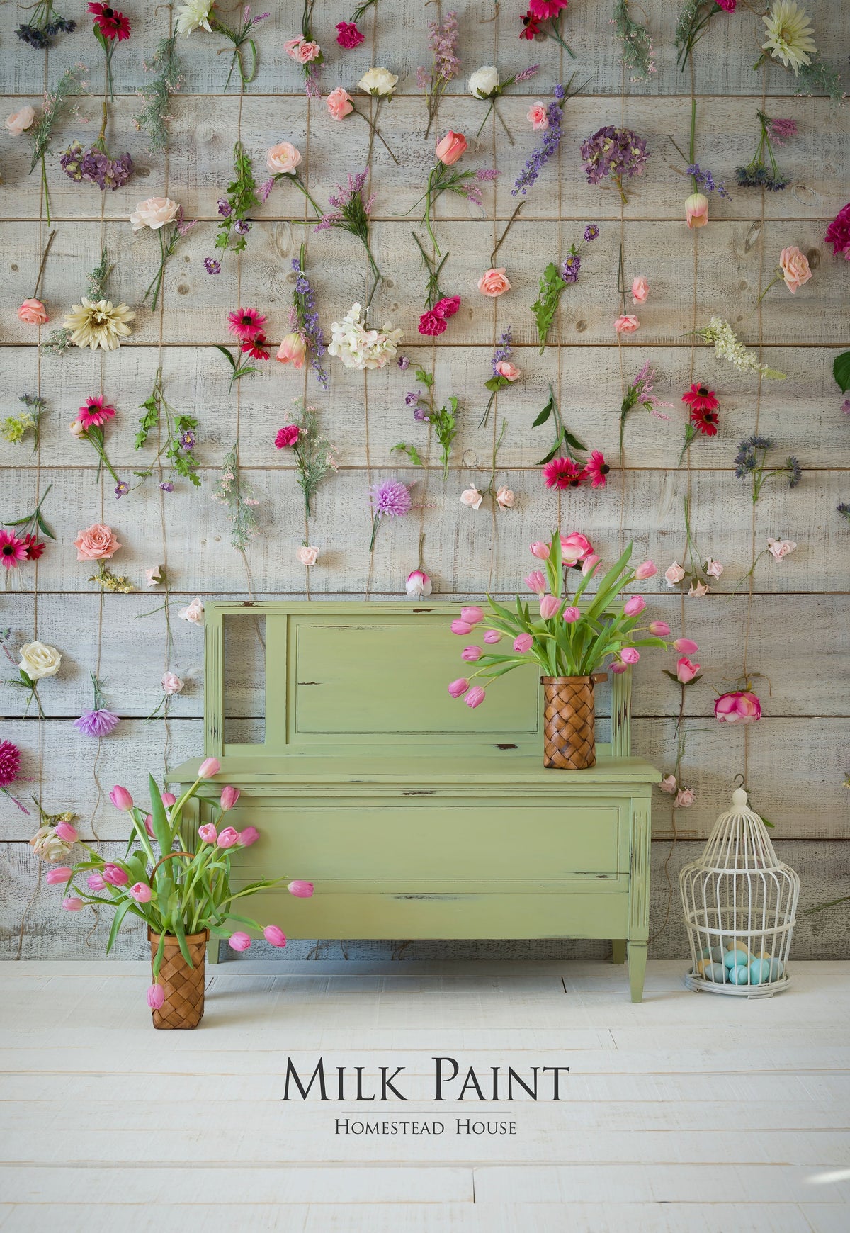 Green wooden console painted with Homestead House Gatineau Milk Paint, pink tulips, and birdcage decor.