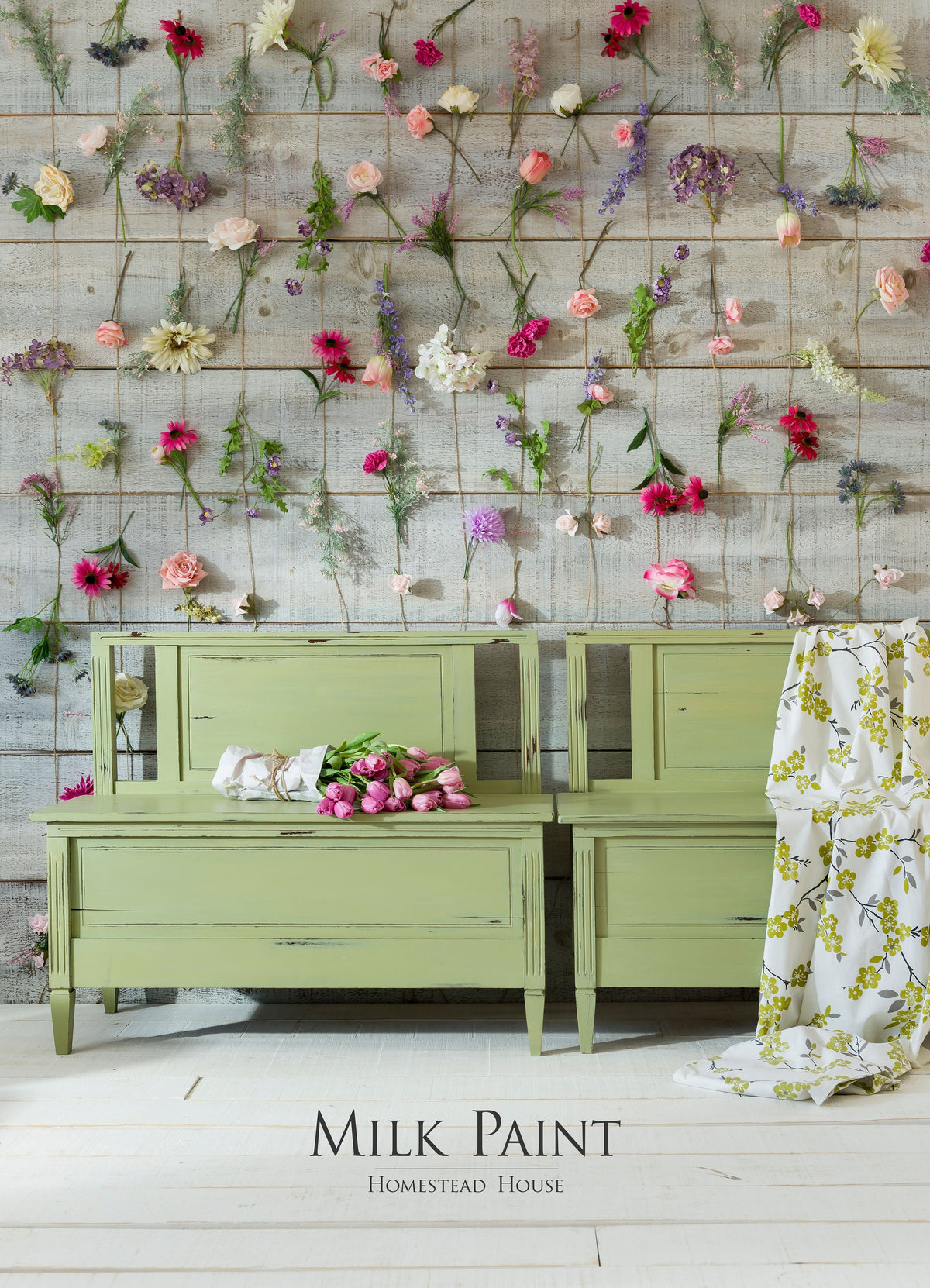 Furniture painted in Gatineau Milk Paint by Homestead House against wood walls with flowers.