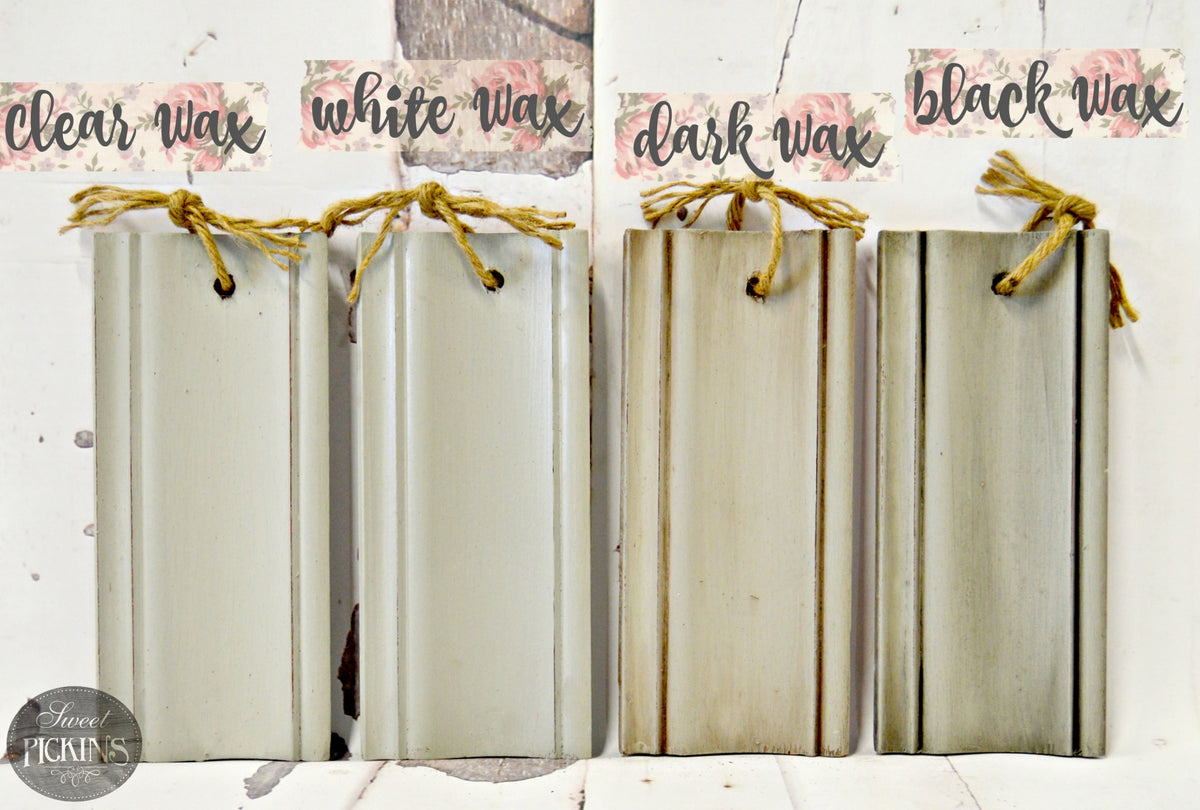 Four wood samples tied with twine display clear, white, dark, and black Haberdash wax by Old Fashioned Milk Paint.