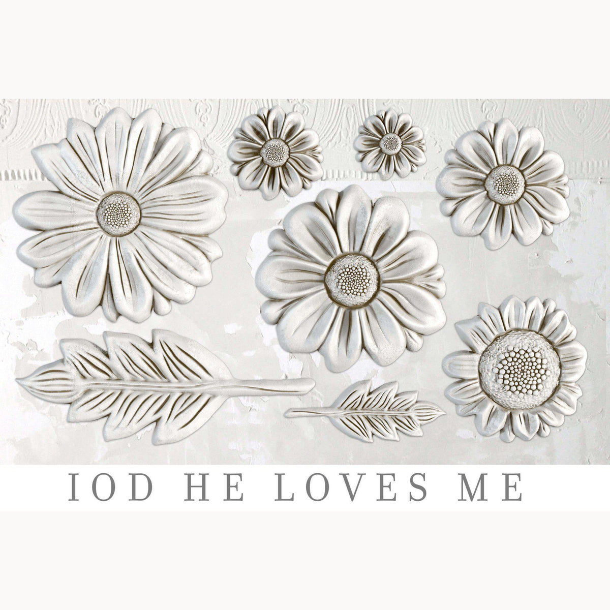 Eight white floral and leaf sculptures made with the I.O.D. He Loves Me Mould on a white background.