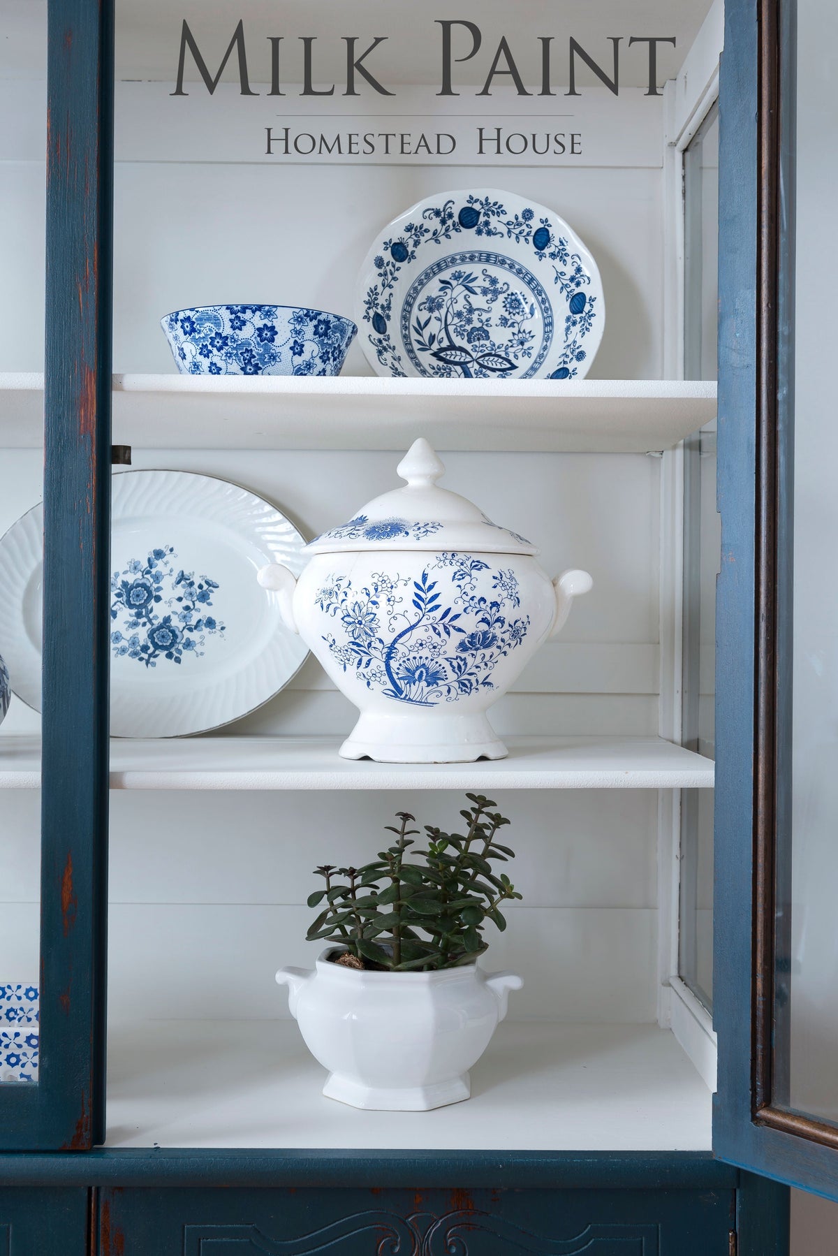 Blue and white dishes with a lidded tureen painted in Homestead Blue Milk Paint by Homestead House on shelves.
