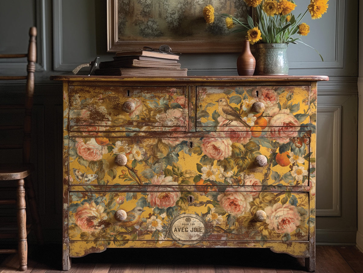 Vintage dresser with I.O.D. Joie Des Roses Transfer, styled with books, sunflowers, and a framed painting.