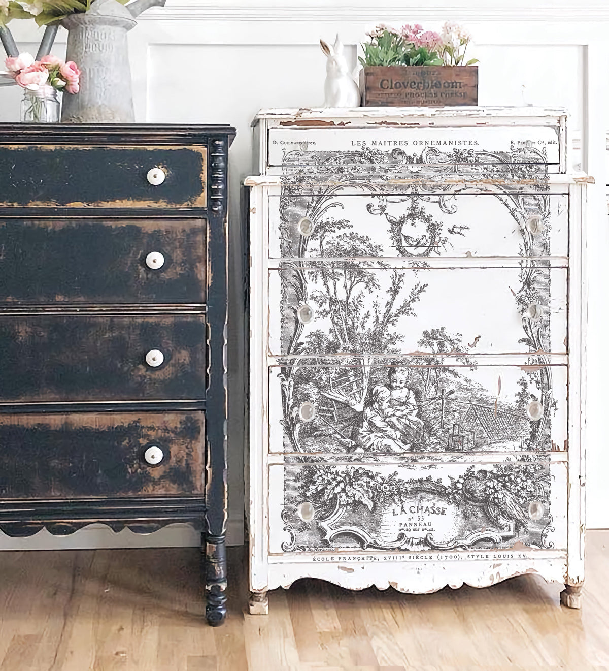 Black distressed dresser and white dresser with I.O.D. La Chasse Paint Inlay pastoral scene, both with decor items.