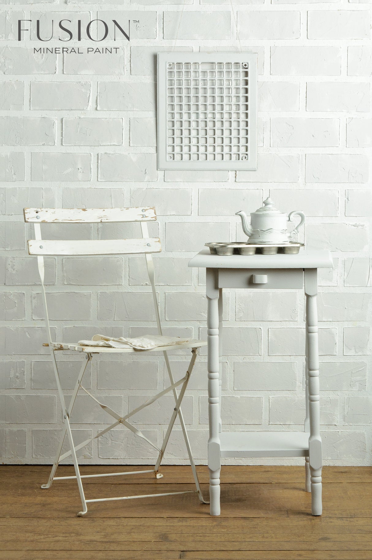 White chair, table, and teapot displayed beside a Fusion Mineral Paint Lamp White acrylic paint sign.
