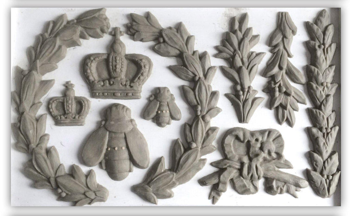 Clay shapes made with Laurel Mould by I.O.D. (Iron Orchid Designs) arranged on a white surface.