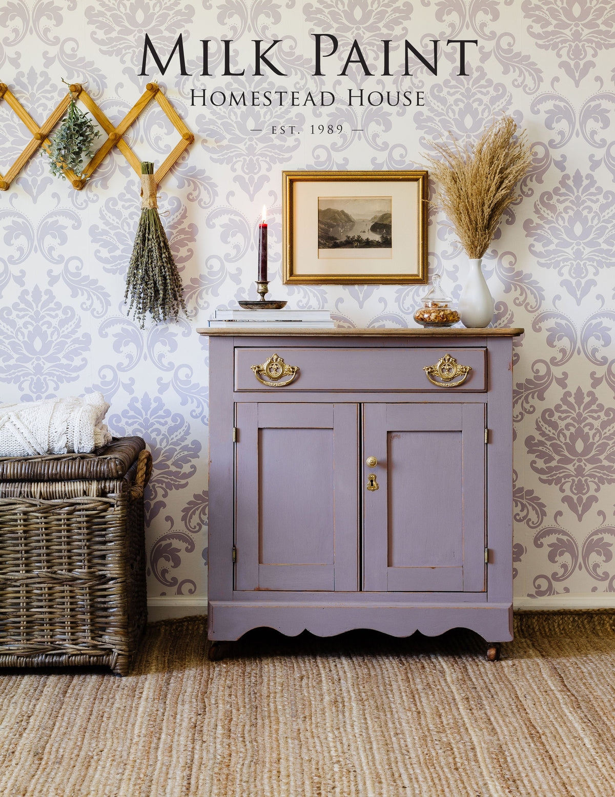 Cabinet painted in Homestead House Lavande Milk Paint, styled with decor and a wicker basket.