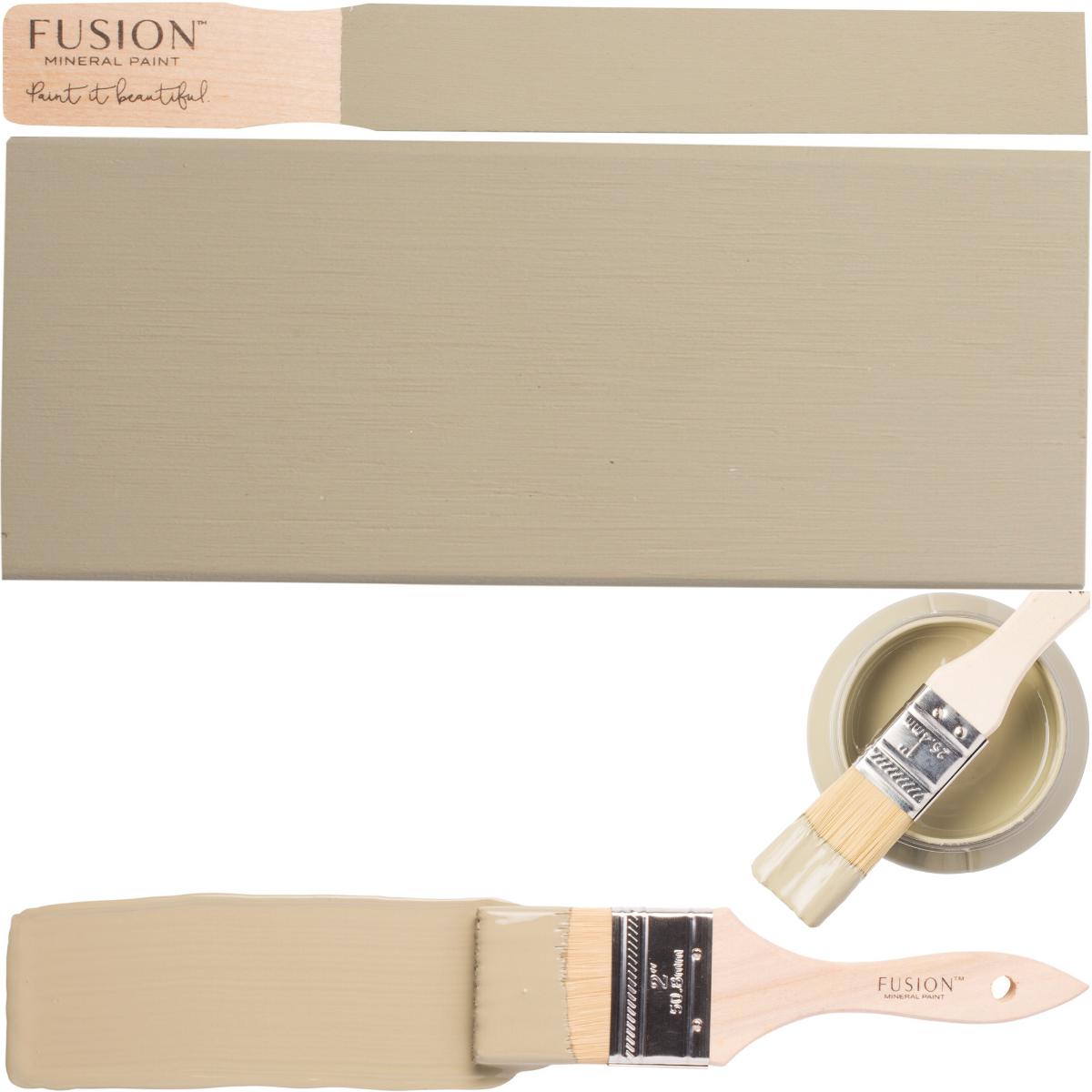 Paintbrush, wooden board, and can of Fusion Mineral Paint in Lichen color displayed side by side.
