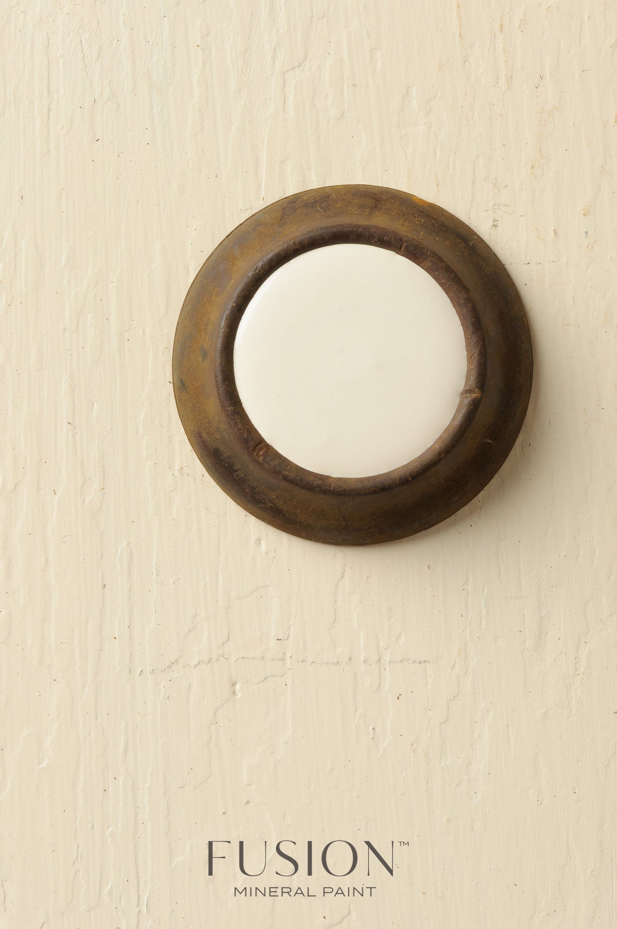Round white ceramic doorbell with a weathered rim, finished in Limestone Fusion Mineral Paint.