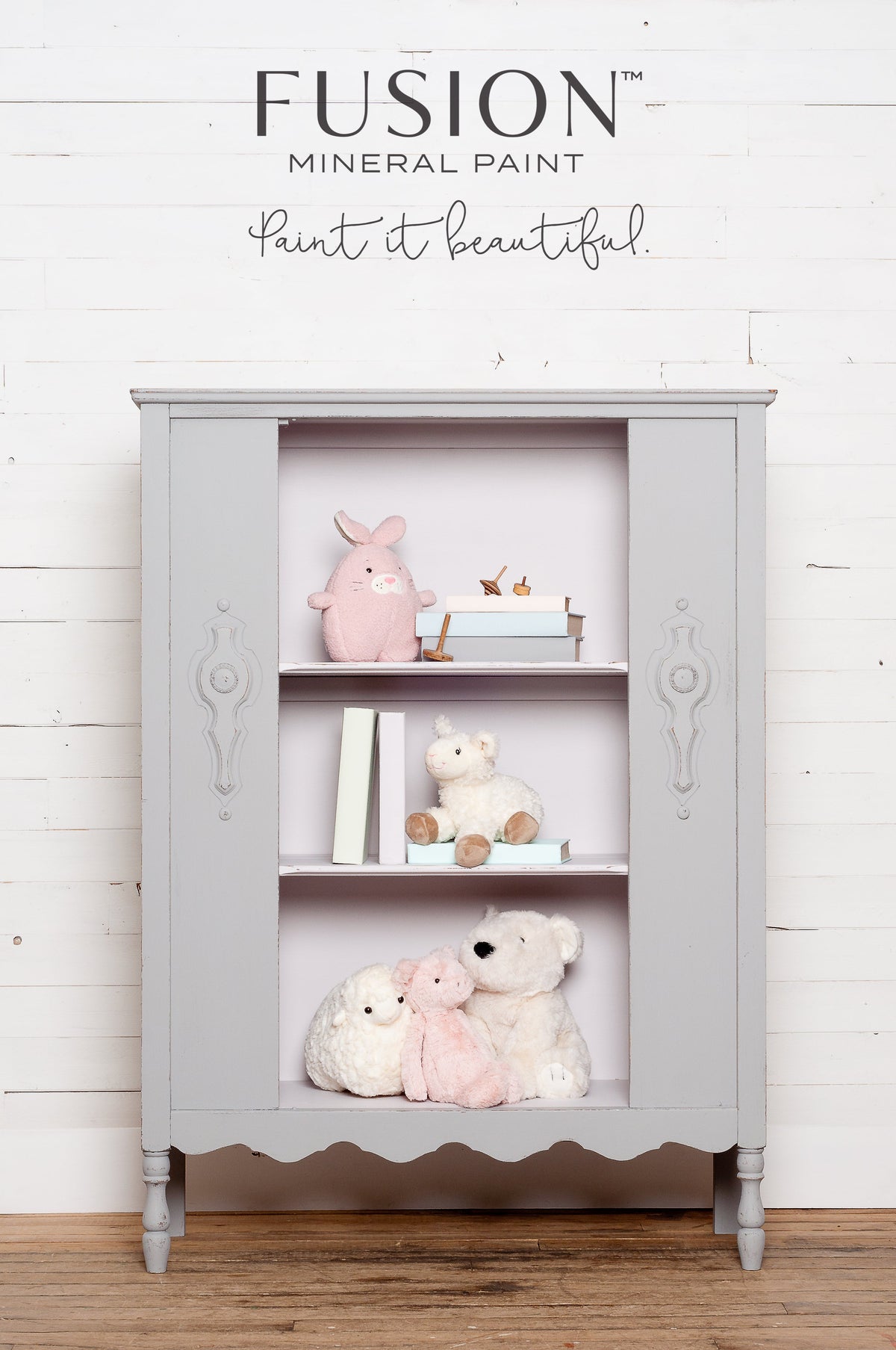 Gray matte cabinet with shelves, shown against a white wood wall in Fusion Mineral Paint’s Little Lamb shade.