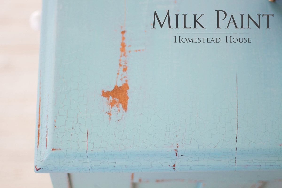 Chipped Loyalist Milk Paint by Homestead House on wood, with “Homestead House Milk Paint” text.