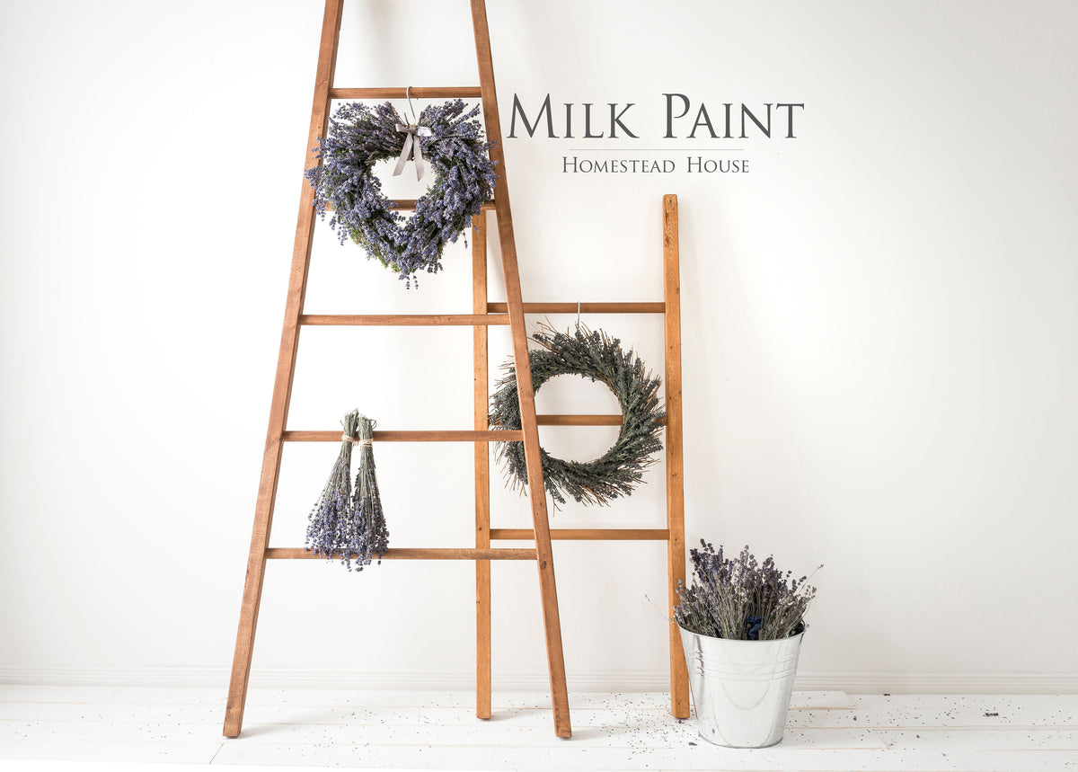 Lavender wreaths beside a white bucket and Fusion Mineral Paint Milk Paint Wood Stain container.