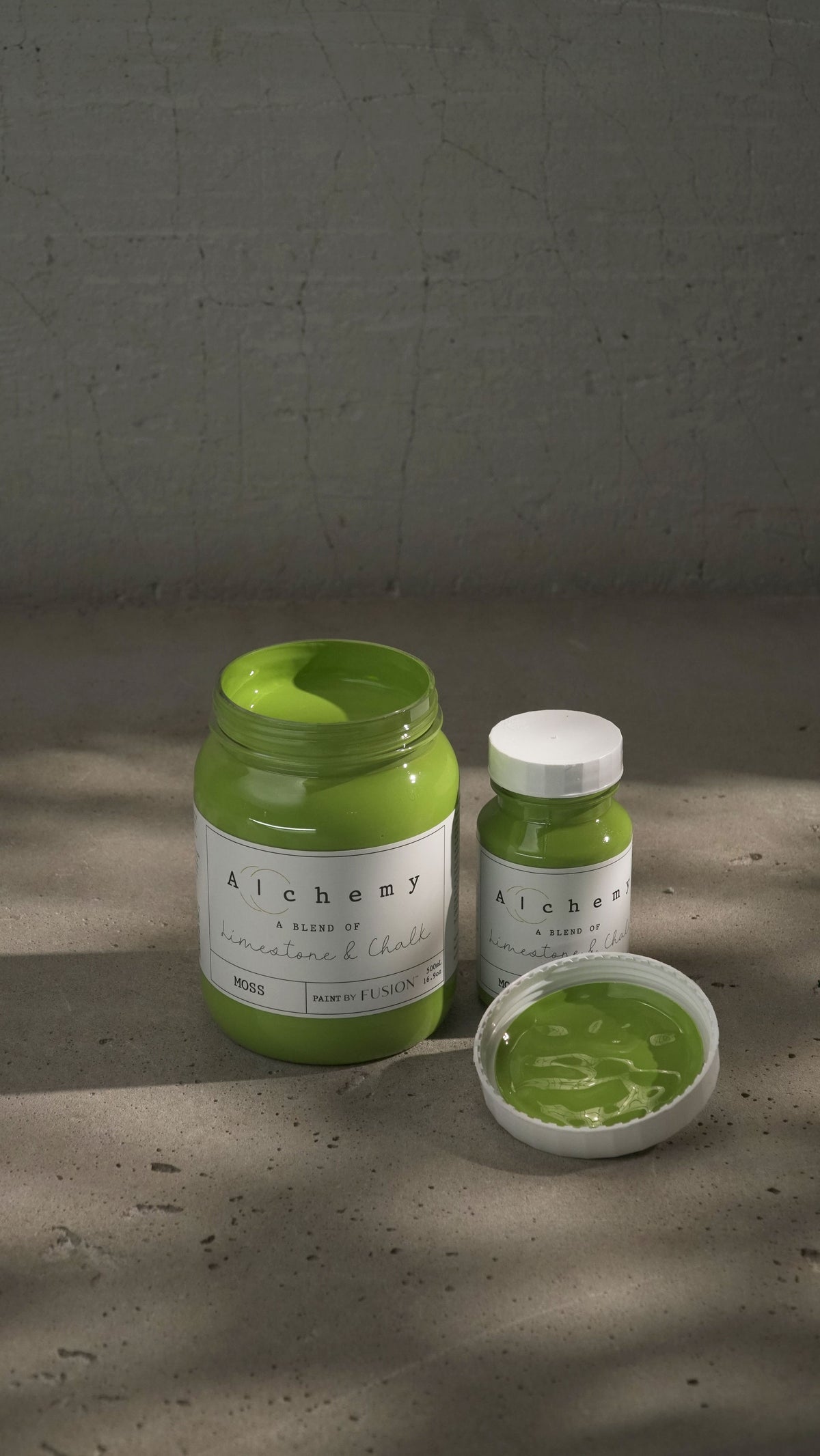 Two Fusion Mineral Paint Moss Alchemy jars, chalk-style, one opened to show paint on the lid.