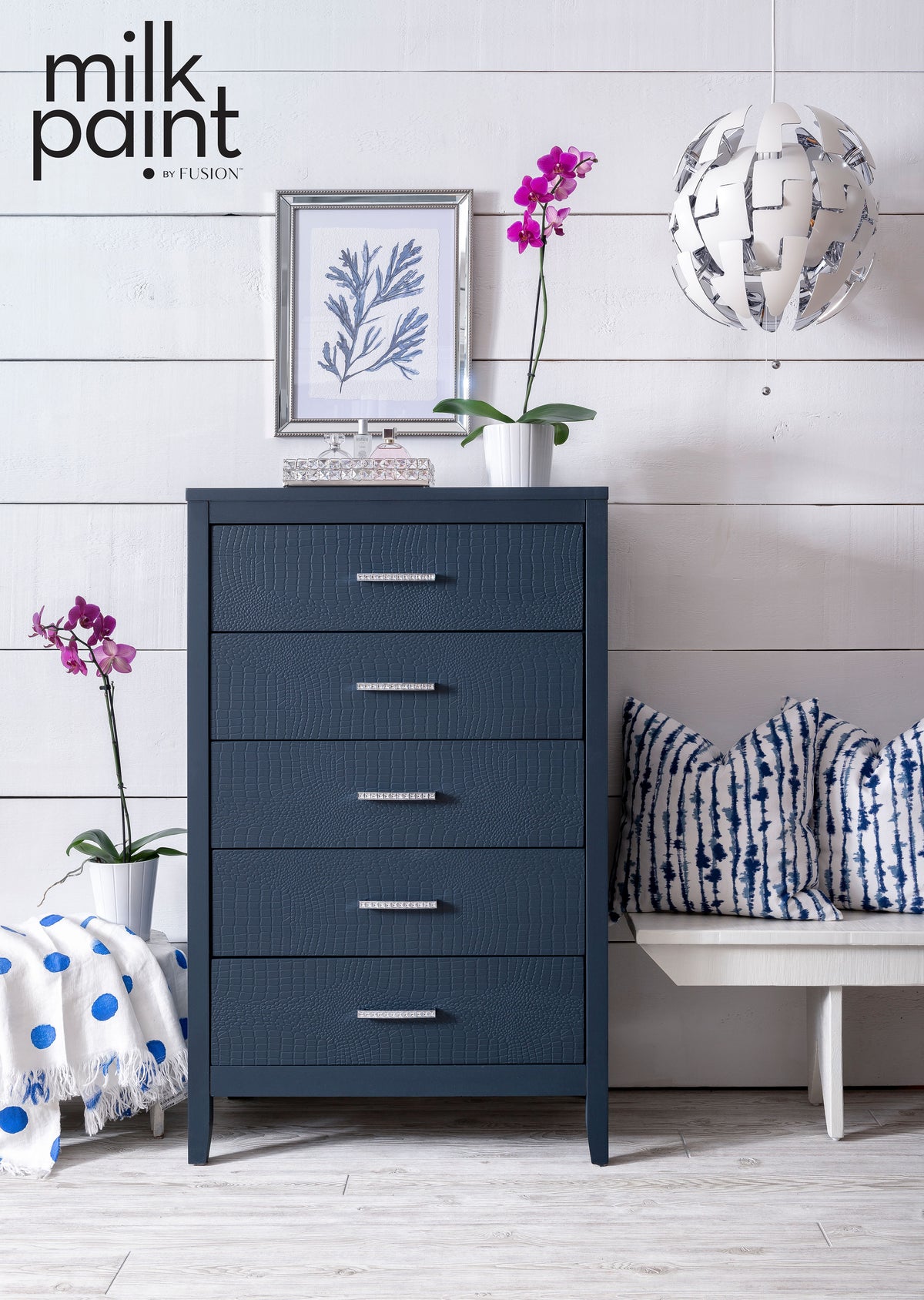 Dresser painted in Night Swim Milk Paint by Fusion, shown against a white wall with plants and art accents.