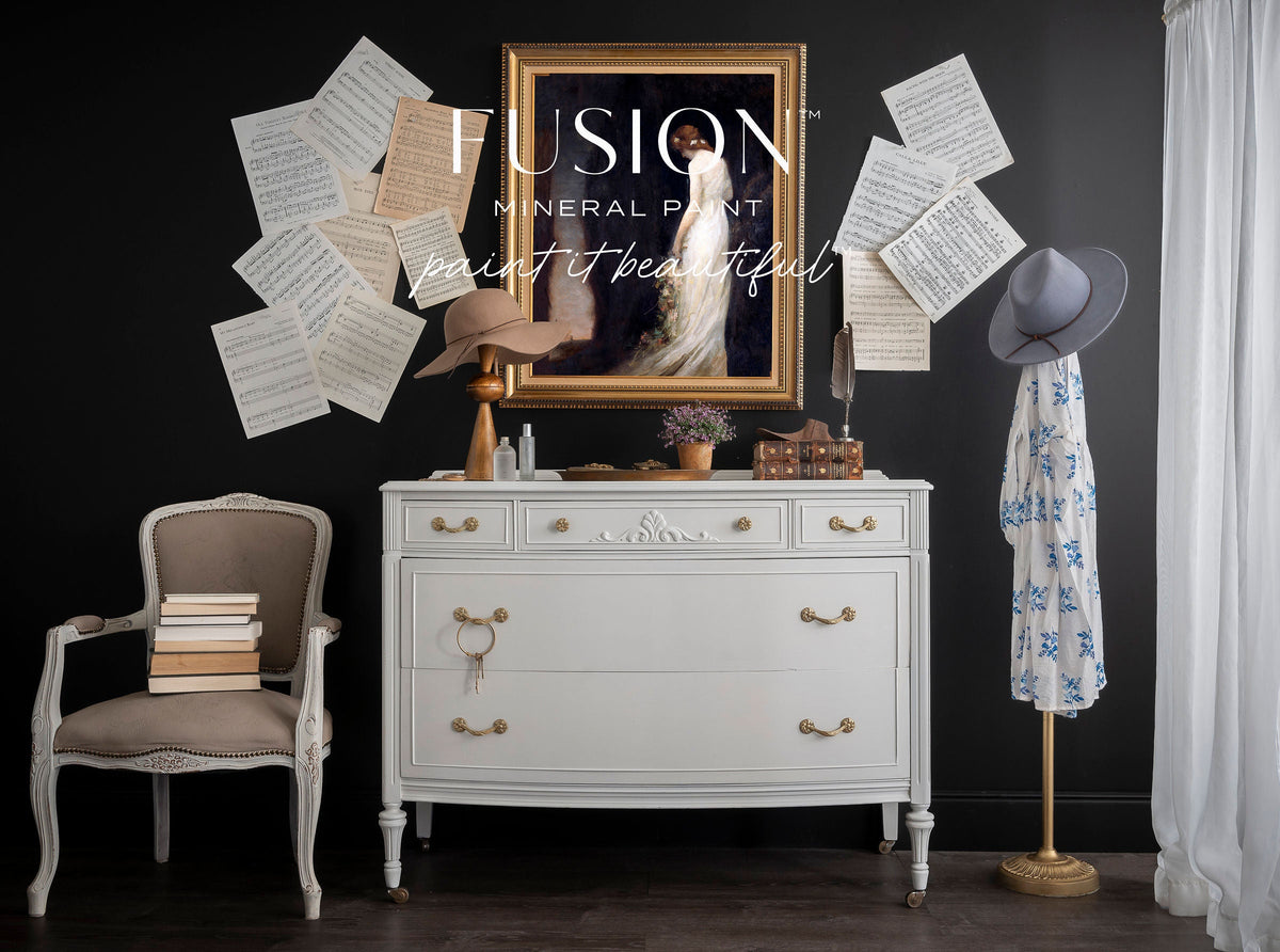 Dresser painted with Parchment Fusion Mineral Paint against a black wall.