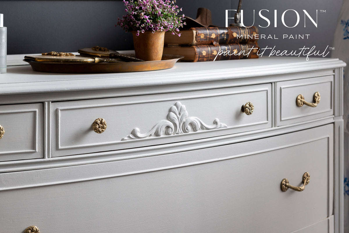 Parchment Fusion Mineral Paint on dresser with gold hardware, shown with the slogan paint it beautiful™.