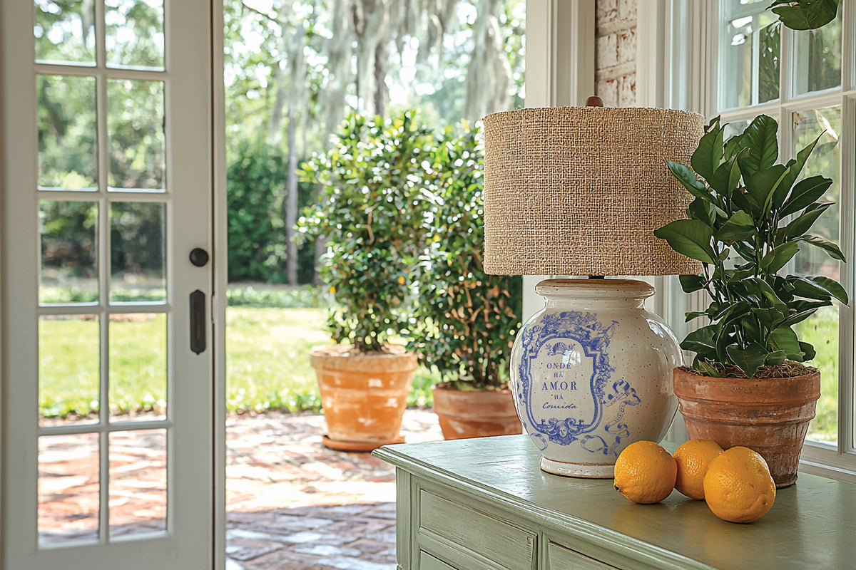 Lamp, plant, and lemons on table with IOD Portofino Paint Inlay near glass doors.