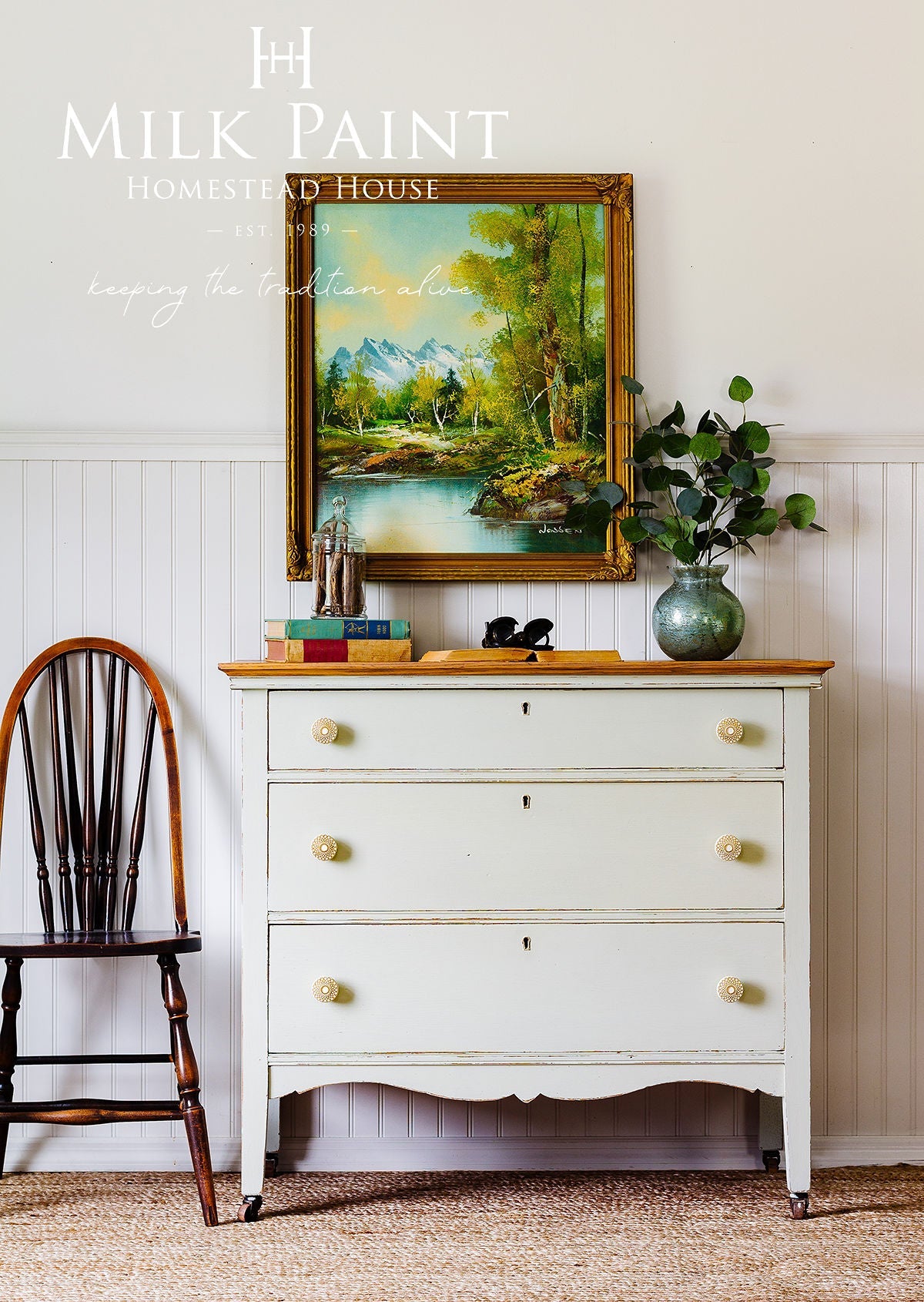 White dresser with wooden top in PotPourri Milk Paint by Homestead House, shown with books and a small vase.